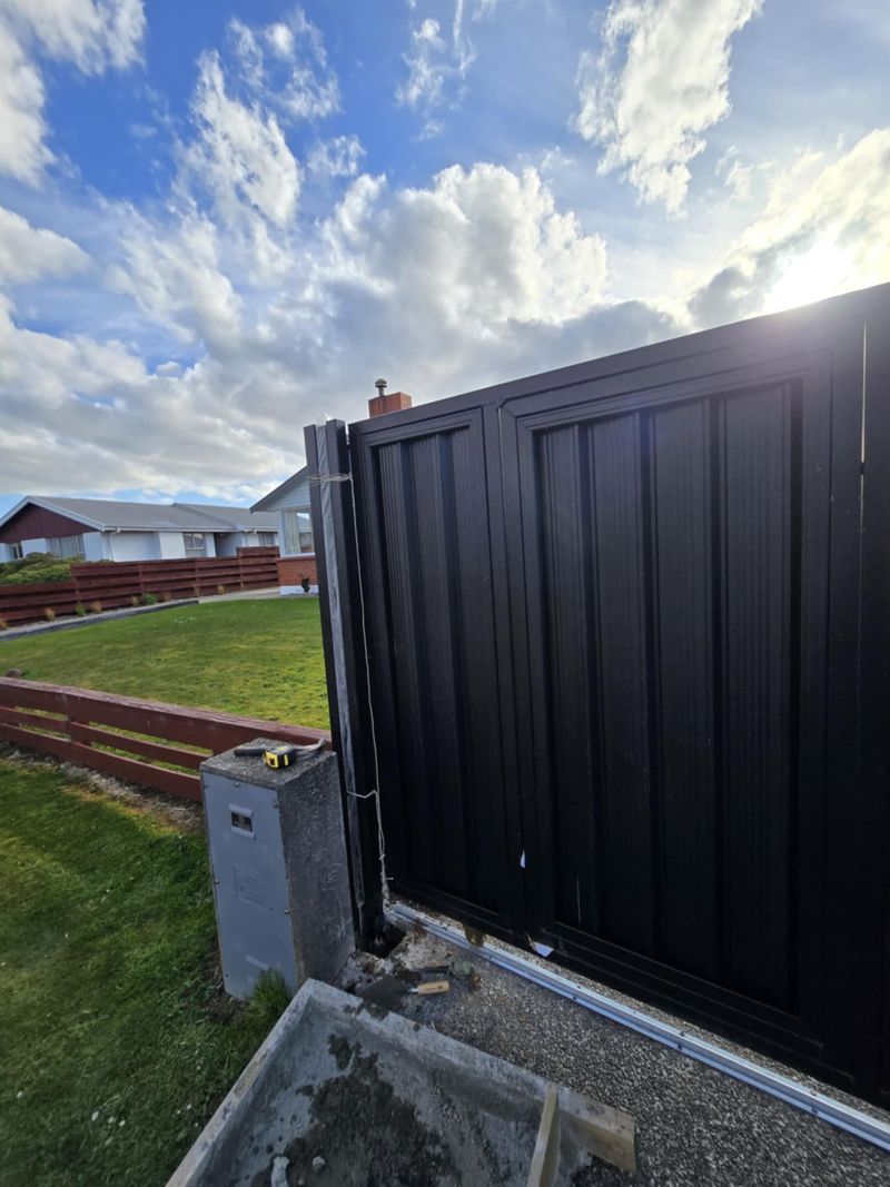 Matte-black driveway gate installed at a Southland property